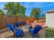 Backyard with a gravel area featuring colorful Adirondack chairs and a fire pit at 3241 Sheridan Blvd, Wheat Ridge, CO 80212