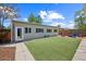 Backyard with artificial turf, exterior building, and outdoor seating at 3241 Sheridan Blvd, Wheat Ridge, CO 80212