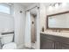 Bright bathroom featuring a shower, toilet and vanity at 3241 Sheridan Blvd, Wheat Ridge, CO 80212