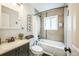 Bathroom featuring a modern vanity, toilet and a tub with a shower at 3241 Sheridan Blvd, Wheat Ridge, CO 80212