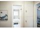 Bright bathroom with a white tub, tile surround, and storage at 3241 Sheridan Blvd, Wheat Ridge, CO 80212