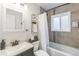 Bathroom featuring a modern vanity, toilet, and shower-tub combination with decorative tiling at 3241 Sheridan Blvd, Wheat Ridge, CO 80212
