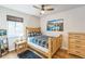 Comfortable bedroom with wood floors, natural light, and mountain-themed decor at 3241 Sheridan Blvd, Wheat Ridge, CO 80212