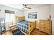 Bright bedroom features hardwood floors, a plaid comforter and a window view at 3241 Sheridan Blvd, Wheat Ridge, CO 80212