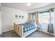 Clean bedroom with a wood-frame bed features a nice view from the window at 3241 Sheridan Blvd, Wheat Ridge, CO 80212