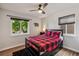 Cozy bedroom with wood floors, a ceiling fan, and ample natural light at 3241 Sheridan Blvd, Wheat Ridge, CO 80212