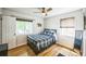 Cozy bedroom features hardwood floors, a ceiling fan and a double bed at 3241 Sheridan Blvd, Wheat Ridge, CO 80212