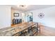 Spacious dining room with wood floors, large table, and eye-catching light fixture at 3241 Sheridan Blvd, Wheat Ridge, CO 80212