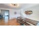 Bright dining room with wood floors and modern decor, adjacent to a kitchen at 3241 Sheridan Blvd, Wheat Ridge, CO 80212