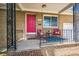 Inviting front porch with seating and vibrant pink door at 3241 Sheridan Blvd, Wheat Ridge, CO 80212