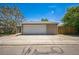 Detached garage with a concrete driveway and an access gate at 3241 Sheridan Blvd, Wheat Ridge, CO 80212