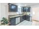 Updated kitchen featuring granite countertops, stainless steel appliances, and bright lighting at 3241 Sheridan Blvd, Wheat Ridge, CO 80212