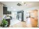 Bright and airy kitchen with stainless appliances, white tiled floors, and open floor plan at 3241 Sheridan Blvd, Wheat Ridge, CO 80212