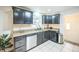 Well-equipped kitchen with stainless steel appliances, dark cabinets, and a bright backsplash at 3241 Sheridan Blvd, Wheat Ridge, CO 80212