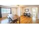 Inviting living room with hardwood floors, a large window, and a modern light fixture at 3241 Sheridan Blvd, Wheat Ridge, CO 80212