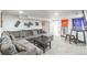 Cozy living room features a plush grey sectional and decor for sports fans at 3241 Sheridan Blvd, Wheat Ridge, CO 80212