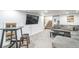 Modern living room features a grey sectional, tv, and a table and chair at 3241 Sheridan Blvd, Wheat Ridge, CO 80212