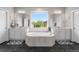 This spacious bathroom features a large soaking tub centered between two vanities and black tiled floors at 1920 Pioneer Cir, Lafayette, CO 80026