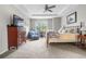 This bedroom features a ceiling fan, a comfortable bed, and ample natural light from the window at 1920 Pioneer Cir, Lafayette, CO 80026