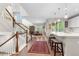 Open-concept entryway, showcasing the kitchen, dining area, and staircase, with natural light flooding the space at 1920 Pioneer Cir, Lafayette, CO 80026