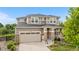 Beautiful two-story home with manicured lawn, stone accents, and a two-car garage on a sunny day at 1920 Pioneer Cir, Lafayette, CO 80026
