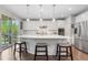 Bright and modern kitchen with white cabinets, stainless steel appliances, and a large center island at 1920 Pioneer Cir, Lafayette, CO 80026