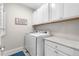 The bright laundry room features a full-sized washer and dryer with lots of cabinet space at 1920 Pioneer Cir, Lafayette, CO 80026