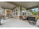Covered patio with stone accents, comfortable seating, and sliding glass doors leading to the interior at 1920 Pioneer Cir, Lafayette, CO 80026