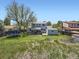Open backyard featuring a trampoline, shed, partial fence and lots of sunlight at 14665 E Stanford Pl, Aurora, CO 80015