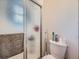Bathroom with a toilet, shower, towel and toiletries at 14665 E Stanford Pl, Aurora, CO 80015