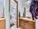 Bathroom featuring a single sink vanity, toilet, and shower with glass door at 14665 E Stanford Pl, Aurora, CO 80015