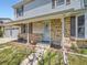 Inviting front porch featuring brick accents, security system, and a convenient location near the garage at 14665 E Stanford Pl, Aurora, CO 80015