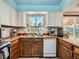 Functional kitchen featuring wooden cabinets, a window above the sink, and essential appliances at 14665 E Stanford Pl, Aurora, CO 80015