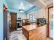 Cozy kitchen with white cabinets, wood countertops, and appliances including a microwave and oven at 14665 E Stanford Pl, Aurora, CO 80015