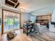 Spacious living room featuring a fireplace, sliding door to patio, and wood-look flooring at 14665 E Stanford Pl, Aurora, CO 80015