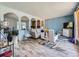 Bright living room with wood floors, soft blue walls, and arched entryways to additional living spaces at 14665 E Stanford Pl, Aurora, CO 80015
