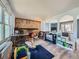 Open-concept living room featuring a brick fireplace, hardwood floors, and arched doorways at 14665 E Stanford Pl, Aurora, CO 80015