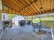 Covered patio with a shed, table and chairs, lattice and a grill for outdoor enjoyment at 14665 E Stanford Pl, Aurora, CO 80015