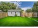 Detached shed in backyard with wooden fence and green lawn at 1164 Chester St, Aurora, CO 80010