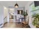 Small dining area with glass-top table and wooden chairs at 1164 Chester St, Aurora, CO 80010