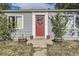 Gray house with red front door, wreath, and potted plants at 1164 Chester St, Aurora, CO 80010