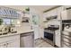 Bright kitchen, stainless steel appliances, and white cabinets at 1164 Chester St, Aurora, CO 80010