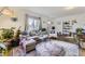 Living room with sectional sofa, rug, and large windows at 1164 Chester St, Aurora, CO 80010