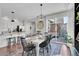 Kitchen and dining area with white table, black chairs, and sliding glass doors at 14653 E Crestridge Dr, Centennial, CO 80015