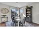 Dining area with a farmhouse table, chandelier, and access to back deck at 14653 E Crestridge Dr, Centennial, CO 80015