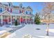 Two-story townhome with red front door and snow-covered yard at 14653 E Crestridge Dr, Centennial, CO 80015