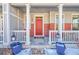 Inviting front porch with red door and white columns at 14653 E Crestridge Dr, Centennial, CO 80015