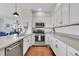 Modern kitchen with white cabinets and stainless steel appliances at 14653 E Crestridge Dr, Centennial, CO 80015