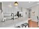 Modern kitchen with white cabinets, quartz counters, and stainless steel appliances at 14653 E Crestridge Dr, Centennial, CO 80015