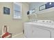 Bright laundry room with washer, dryer, and shelving at 14653 E Crestridge Dr, Centennial, CO 80015